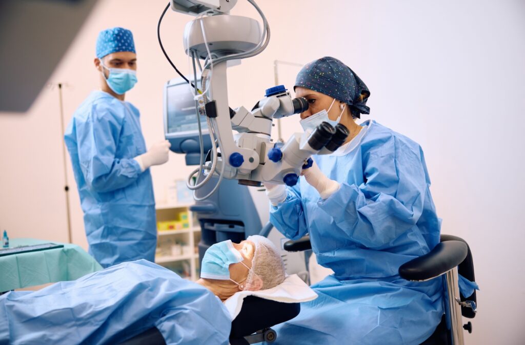 An adult with a lazy eye lays on a surgical table while their opthalmologist prepares to operate on their lazy eye.