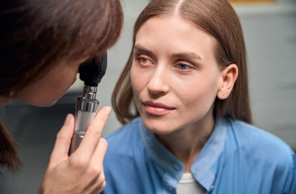 An optometrist shines a light into a patient’s eye as part of an eye exam to find solutions to red eyes